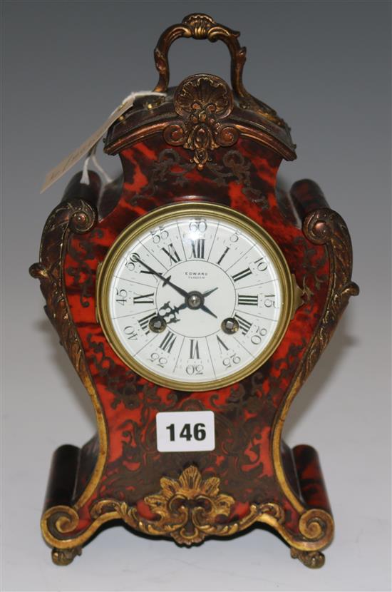 A red boulle work mantel clock, 30cms